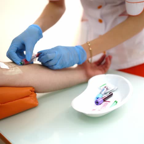 nurse collecting blood from patient