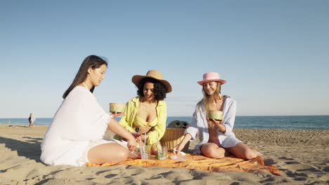 women enjoying a picnic on the beach