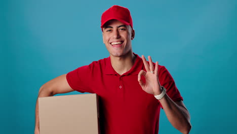 delivery man with package giving ok sign