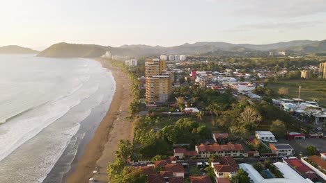 Seaside-town-of-Jaco-along-the-beautiful,-tropical-coast-of-Costa-Rica-at-sunset