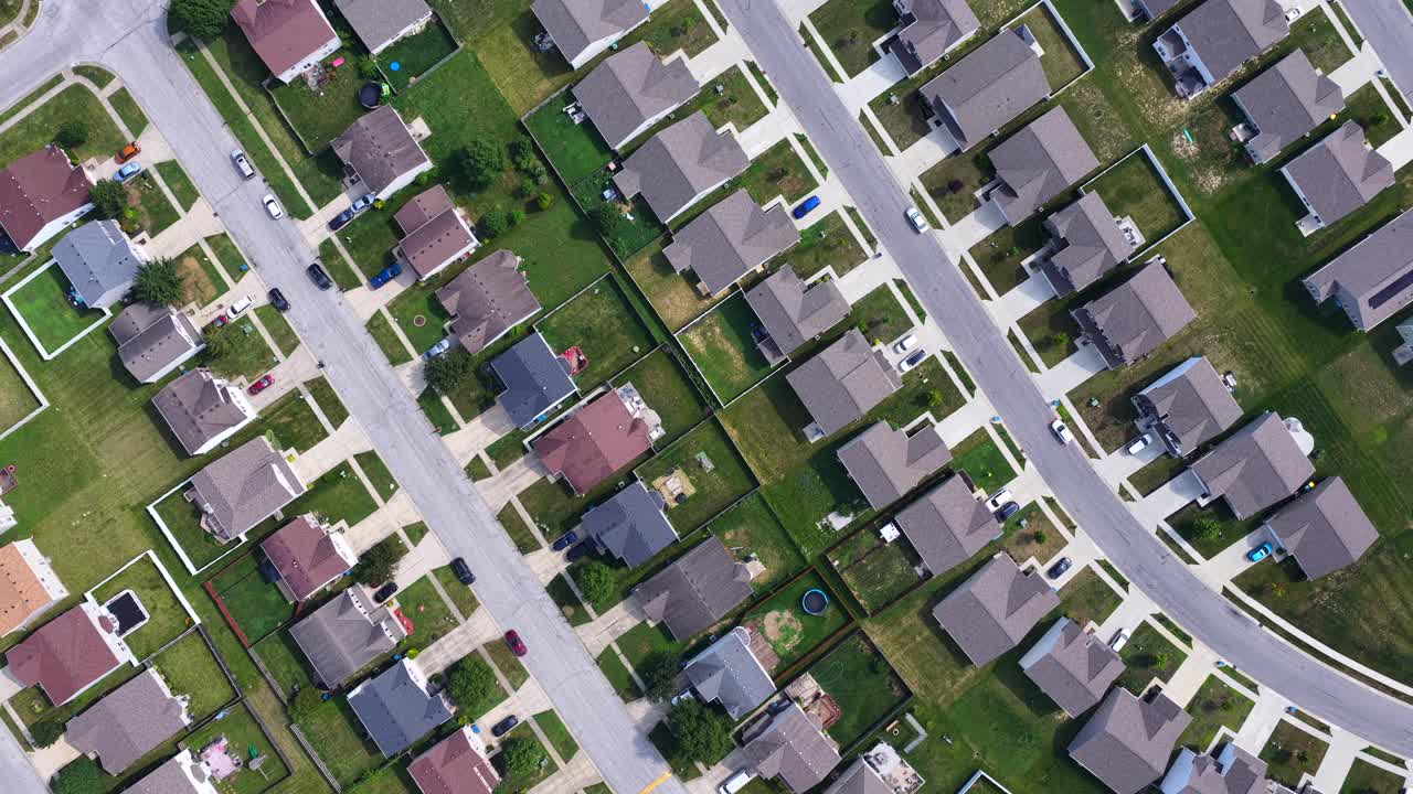 Overhead aerial of neighborhood streets in Indiana with lush green lawns and clean streets