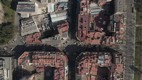 Top-down-shot-of-square-blocks-of-buildings-in-city.-Fly-above-urban-borough-on-sunny-day.-Barcelona,-Spain