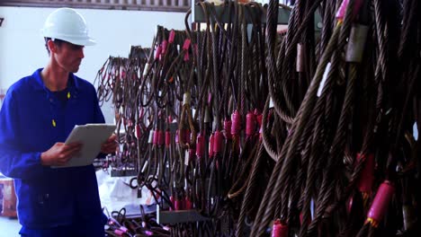 male engineer maintaining stocks in workshop 4k