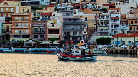 boat cruising in the sea along the sitia town in lasithi, crete, greece. - wide shot