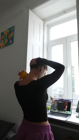 woman stretching her neck and shoulders at home