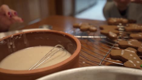 close-up sliding shot of gingerbread man cookies laying in a baking tray
