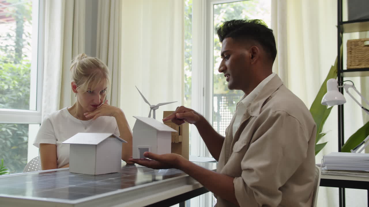 Manager Explaining to Client How Alternative Energy Can Be Implemented in House