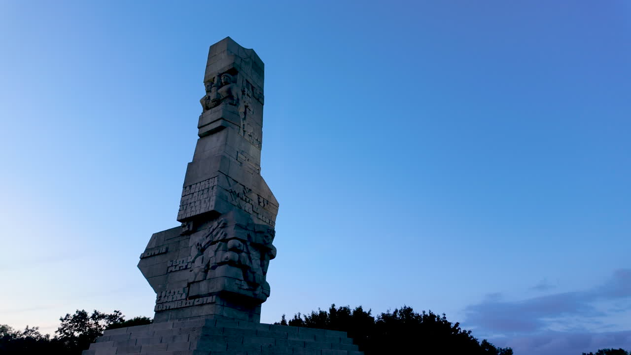 A low-angle shot of the monumental Westerplatte monument in Poland against a clear blue sky. A symbol of World War II history, heroism, and remembrance