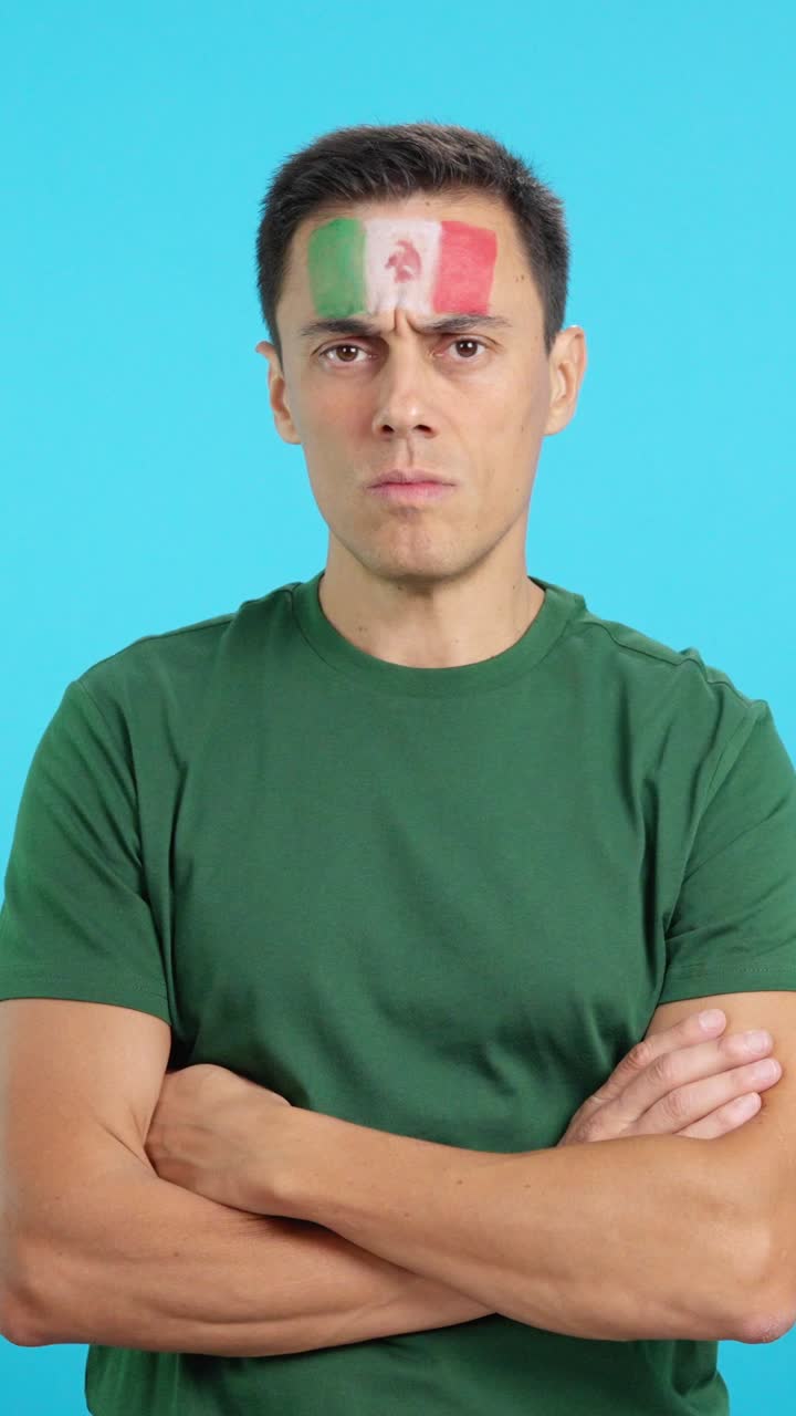 Dignified and serious man with mexican flag painted on face