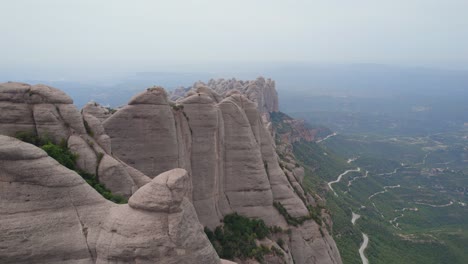 Mountain-peaks-in-Montserrat-Natural-park,-aerial-establishing-view