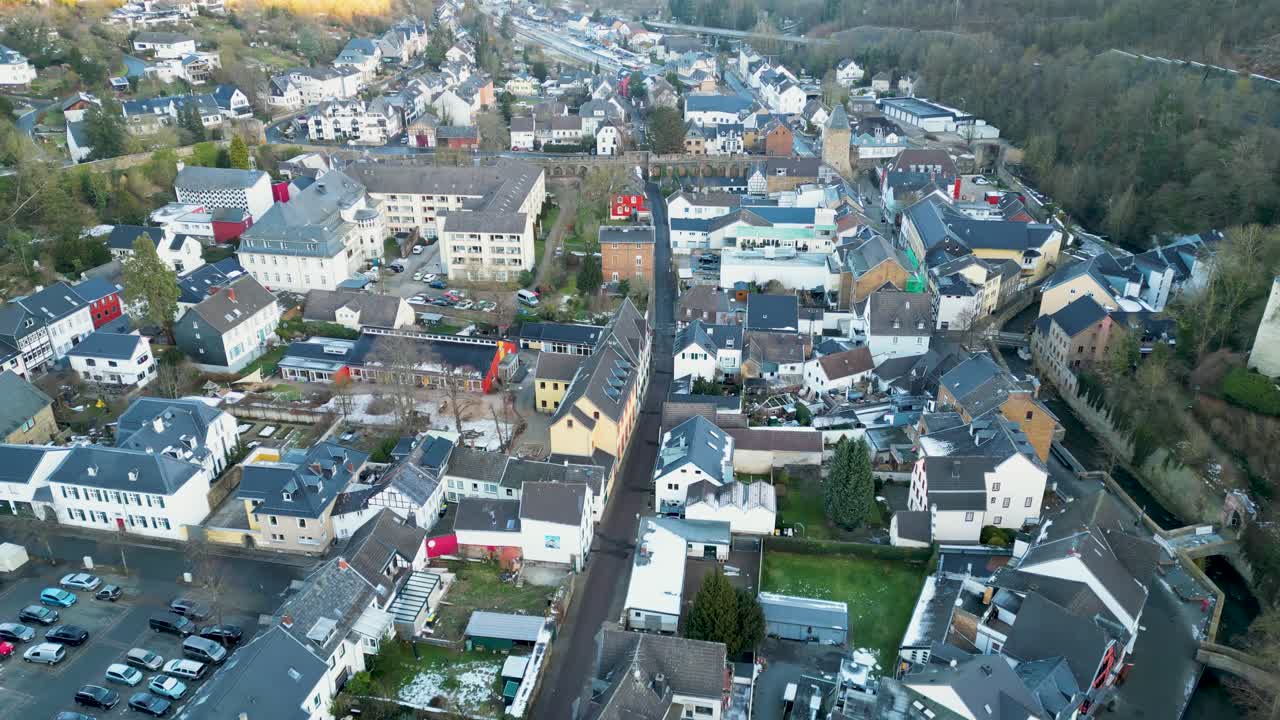 Smooth forward-moving drone flight over the rooftops and narrow streets of Bad Münstereifel.