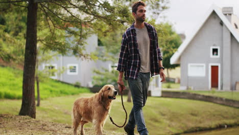 a handsome young man walking with his dog