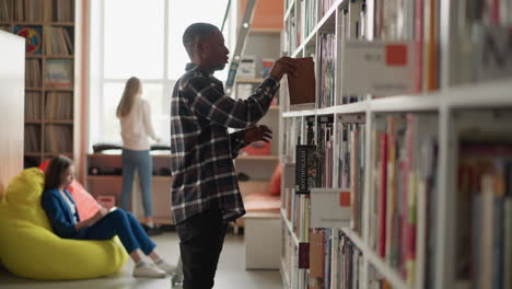 a man and two women reading books in a library