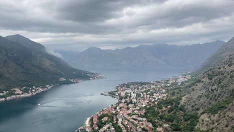 Aerial-shot-of-the-historic-town-Kotor-surrounded-by-mountains,-Montenegro