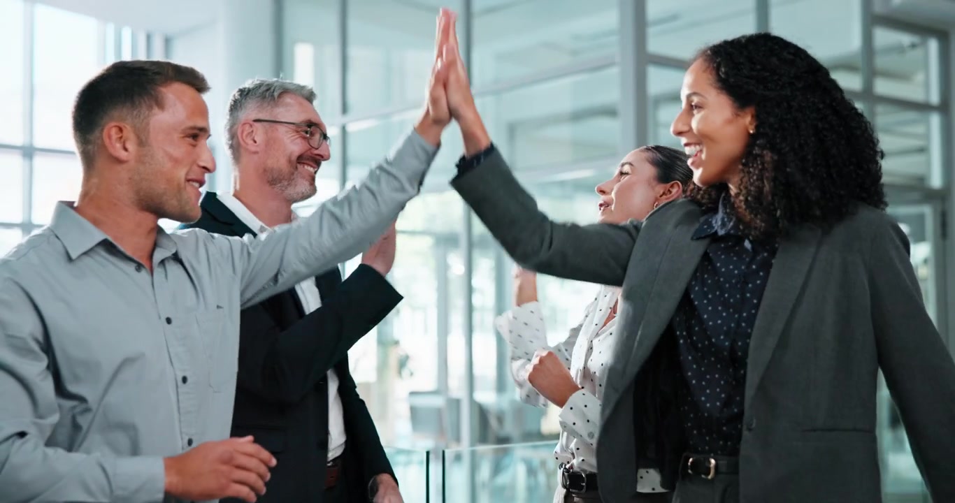 Diverse Business Team Celebrating Success with High Fives in Office