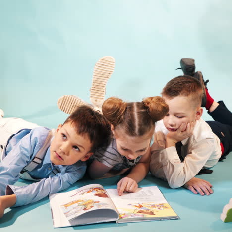 curious children reading book together. studio shooting of children square video