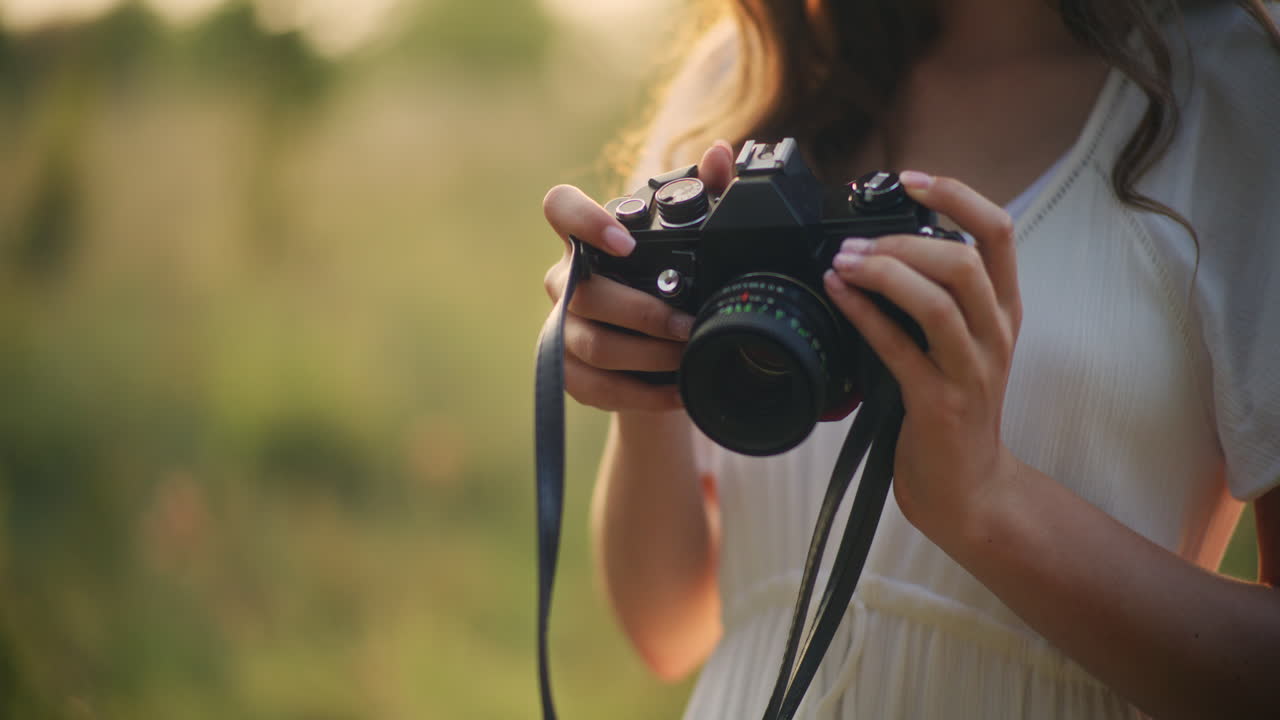 Happy girl snaps photos in wild grass