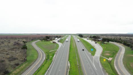 semi-truck parking lot on highway side in aerial drone view, usa