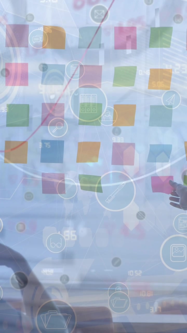 Animation of icons and graphs over diverse businesswoman and businessman talking in office