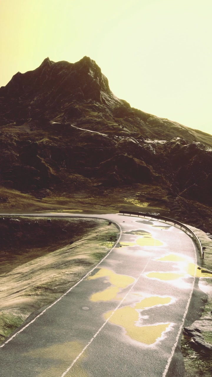 Scenic road curves around mountain with sunset light shining down