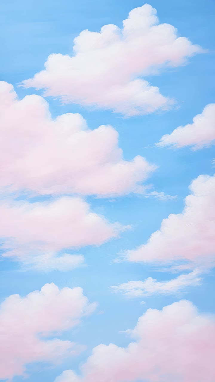 Dreamy sky with fluffy pink clouds against a blue backdrop, captured from a low-angle