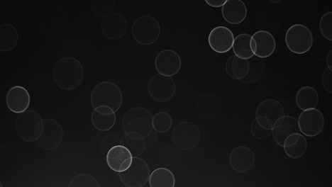 bokeh desfocalizado de luces de círculo sobre fondo negro