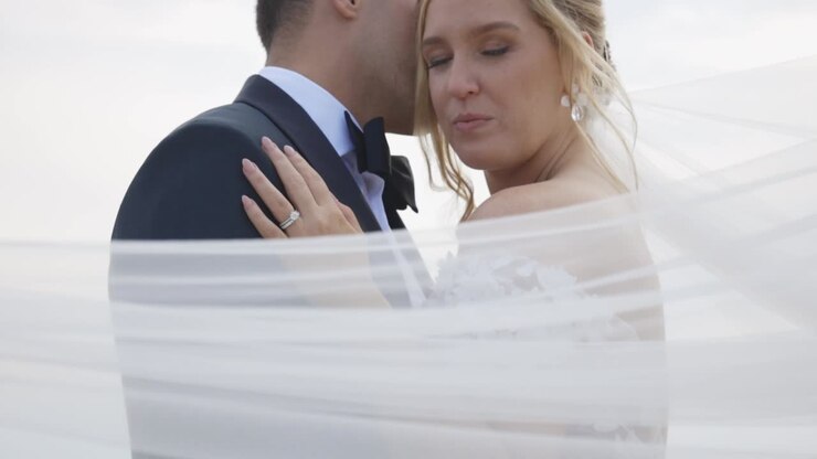 Bride laughs with groom as Weil blows in the wind
