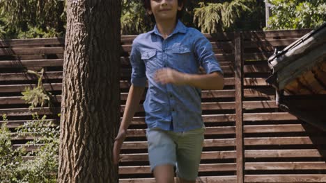 boy running with dog in garden