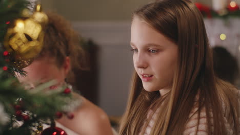 a girl decorating the christmas tree