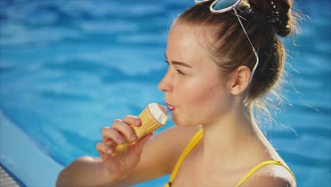 teenage girl enjoying ice cream by the pool