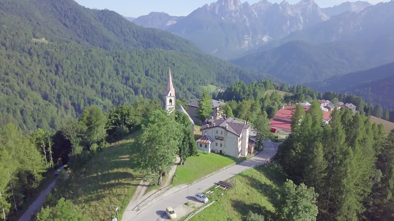 Drone flying around mountain village church