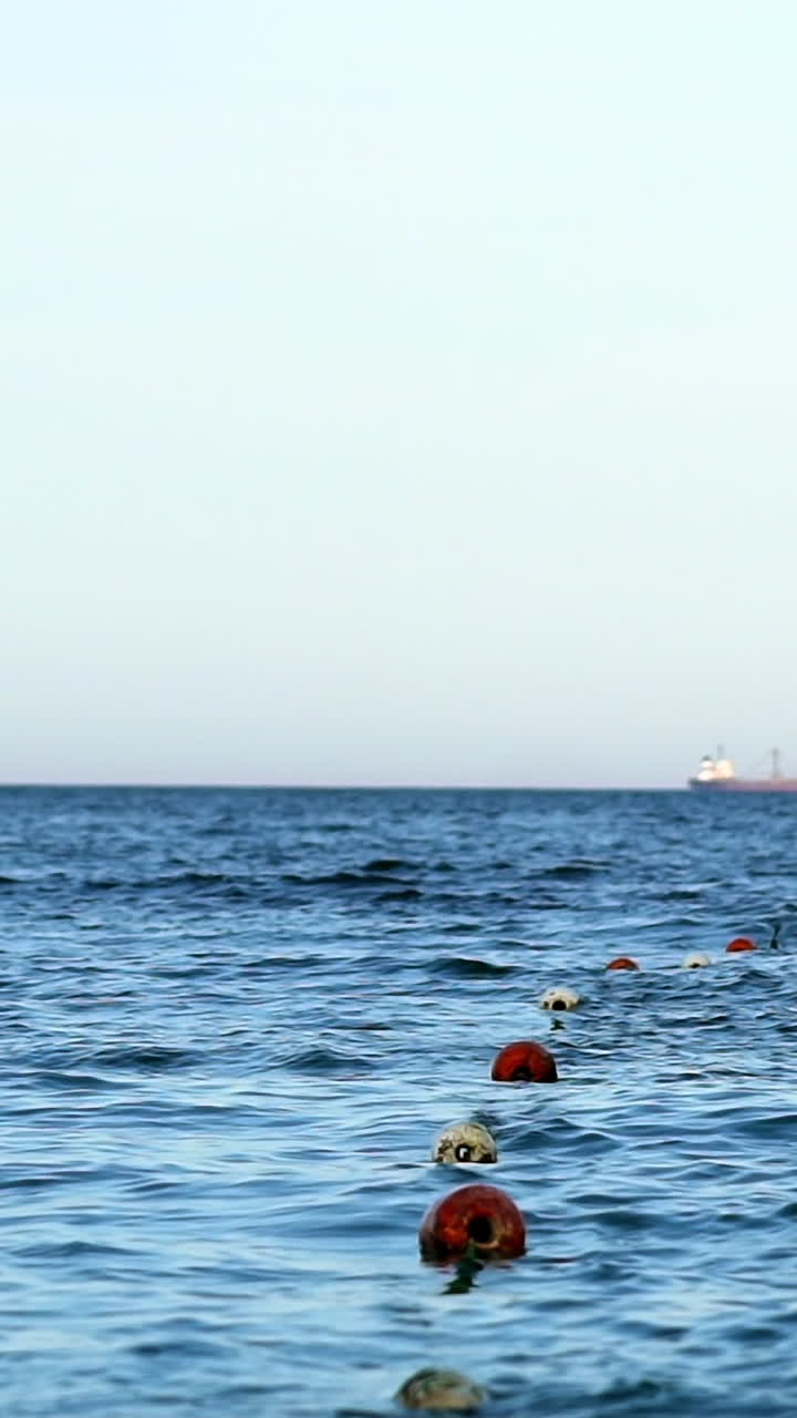 Floating buoy on blue sea. Lots of empty red mooring buoys floating on water