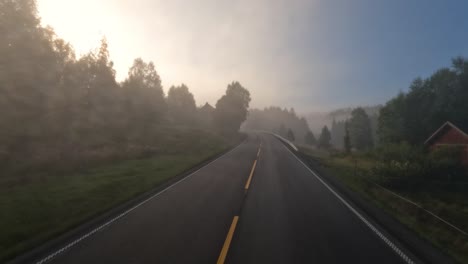 fog on a norway road. pov car trip. vehicle point-of-view driving a car on a road in norway.
