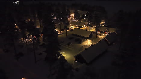 aerial view of a illuminated carelian village, winter evening in kainuu, finland