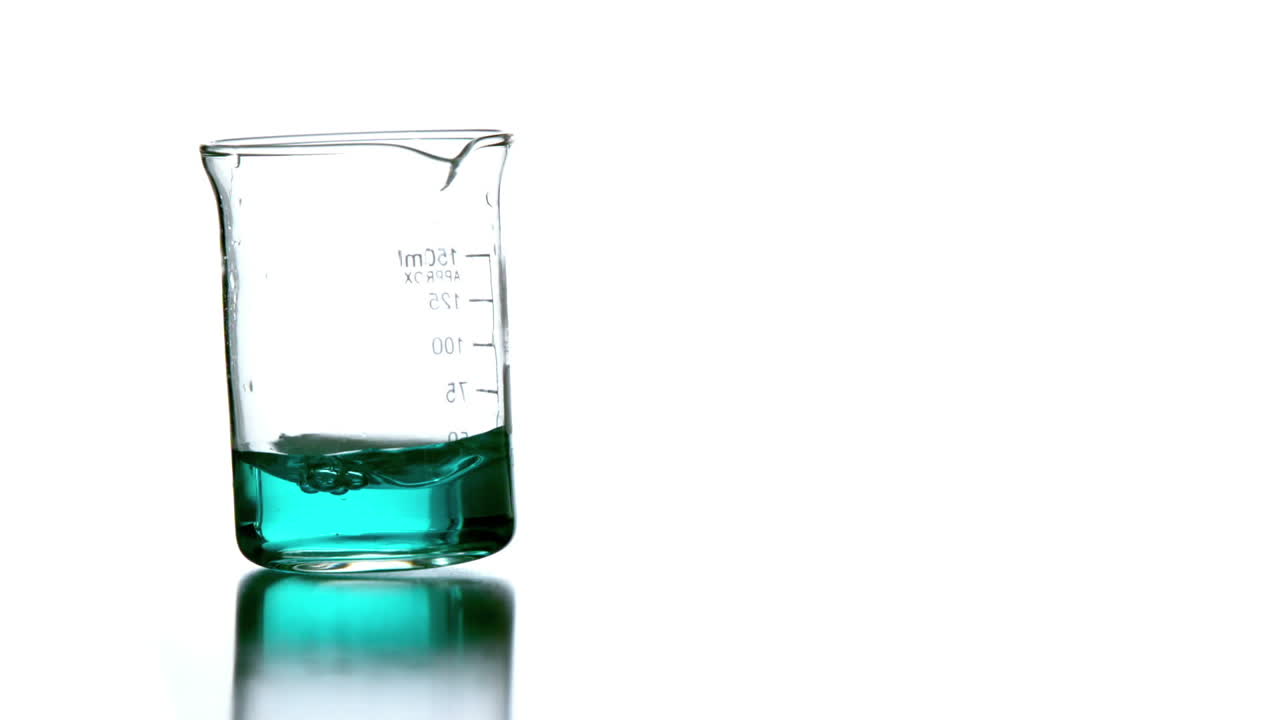 Blue liquid swirling in beaker