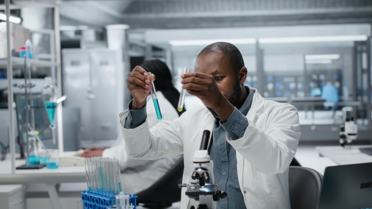 Lab assay development specialist investigating blue liquid polymer