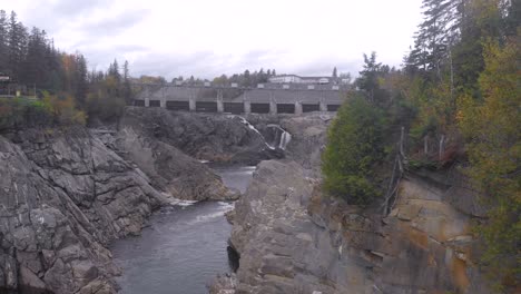 slow dolly in shot of the grand falls showcasing the stunning river below then revealing the waterfall behind the trees