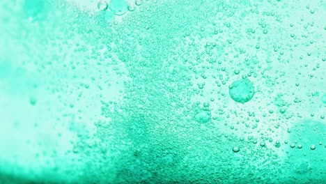 macro shot of bright blue water with many sparkling bubbles