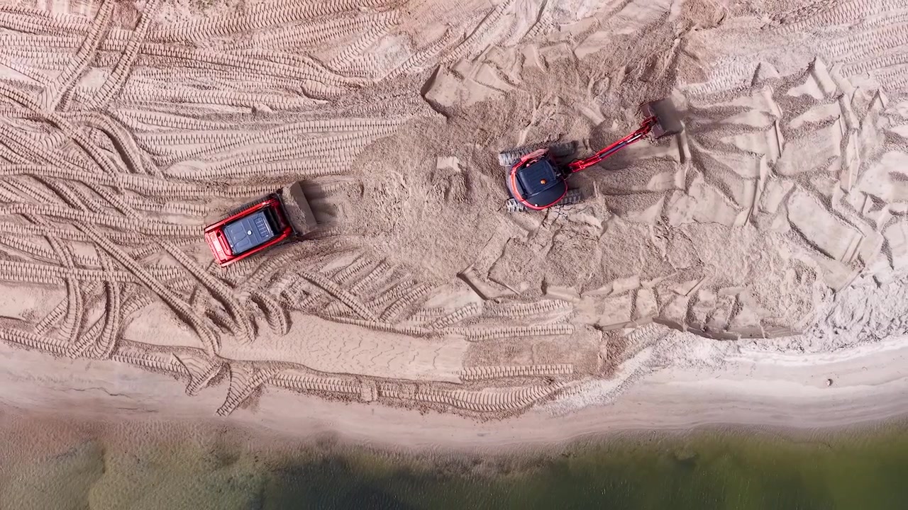 Aerial View of Excavator and Skid Steer Loader Moving Sand