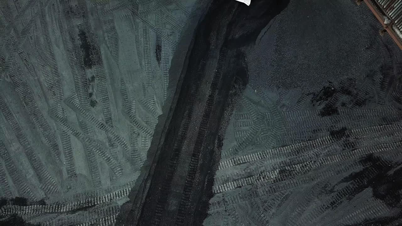 Bulldozer at coal warehouse. Tractor using for loading coal into trucks for further transport