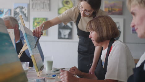 Slow-motion-Old-people-attend-drawing-courses.-The-teacher-helps-pensioners-who-attend-drawing-courses-to-draw.-A-group-of-retired-friends-at-a-drawing-lesson