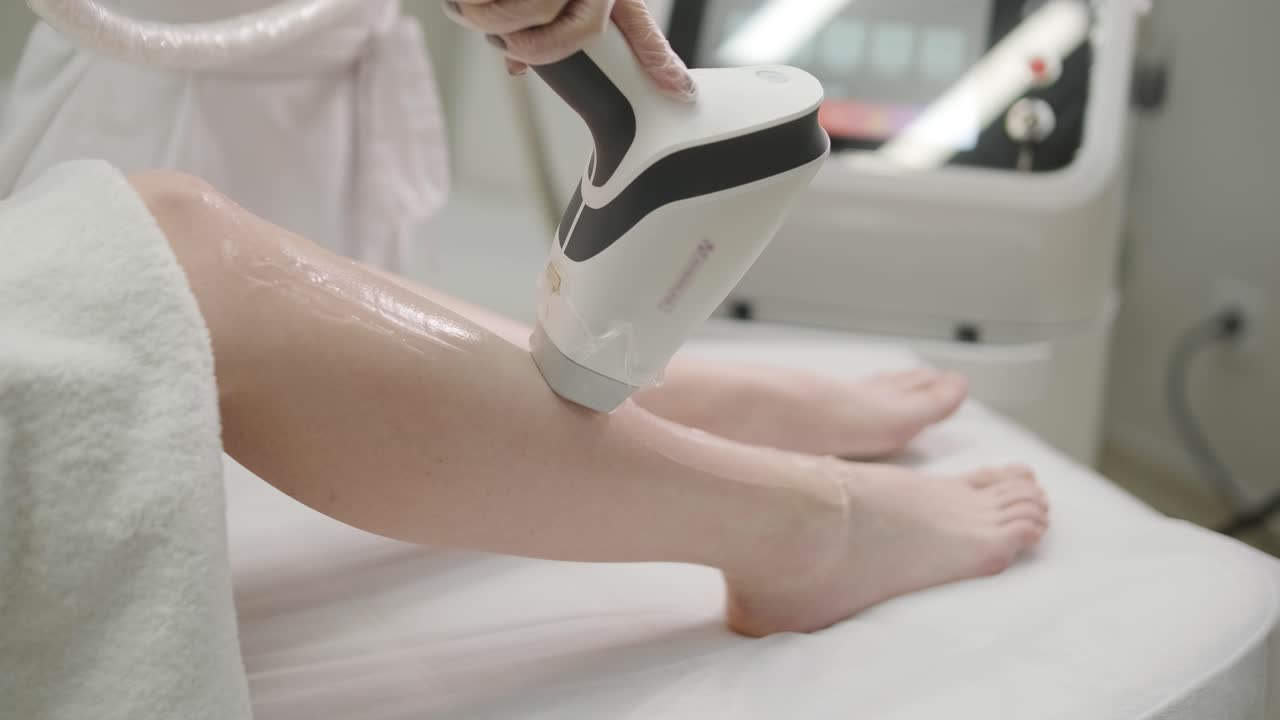 Laser epilation and cosmetology in beauty salon. Cosmetology, spa and hair removal concept. Laser hair removal procedure of female legs. doctor in gloves.
