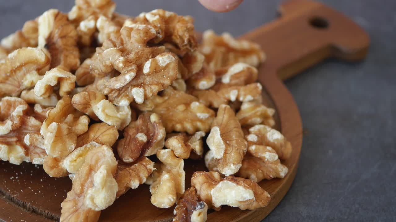 Pile of Walnuts on Wooden Board