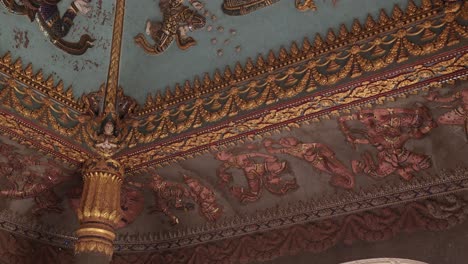 Colorful-religious-paintings-and-carvings-on-the-interior-of-the-archway-of-Patuxai-Victory-Monument-in-the-center-of-Vientiane,-Laos