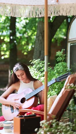 girl playing guitar in a garden