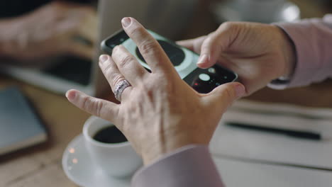 close up business woman hands using smartphone taking photo of fresh coffee sharing lifestyle on social media enjoying working in relaxed cafe