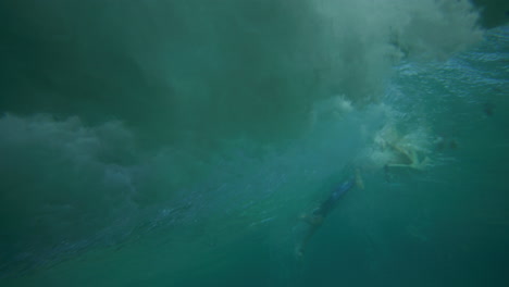 Surfer-riding-on-a-wave-in-crystal-clear-water-in-Byron-Bay-Australia-shot-from-underwater-in-slow-motion