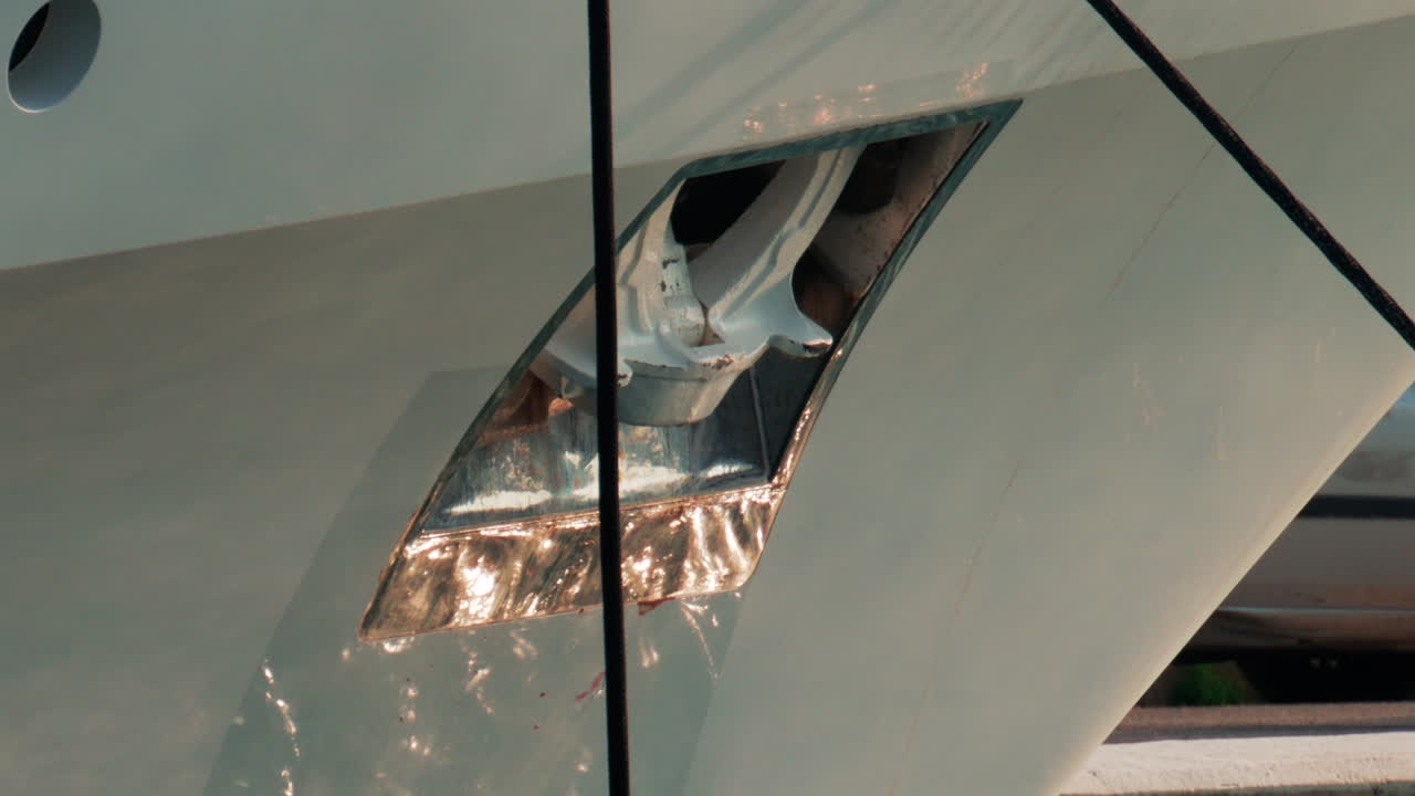 A detailed close up of a yacht's metal anchor shining under the afternoon sun in Cannes Marina