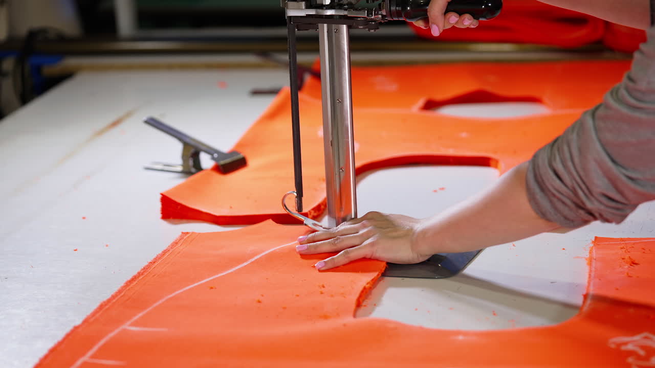 Seamstress works on sewing machine