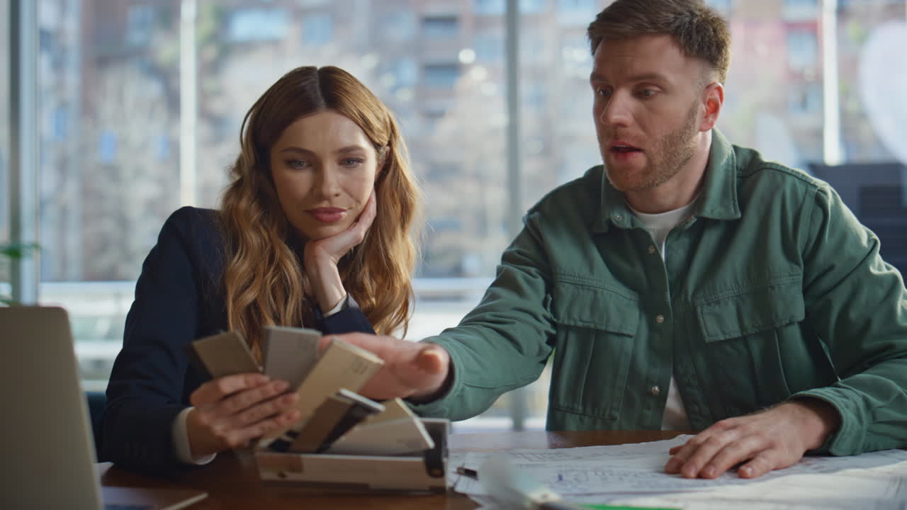 Two colleagues discussing project in office workspace closeup. Confident man